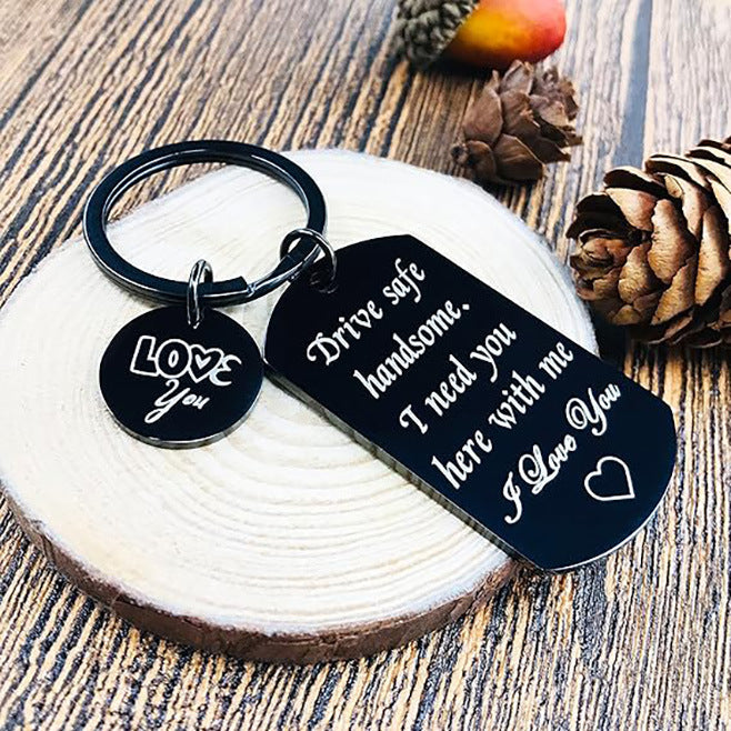 Black dog-tag keychain with ring, 'Drive safe handsome' text and 'Love' charm