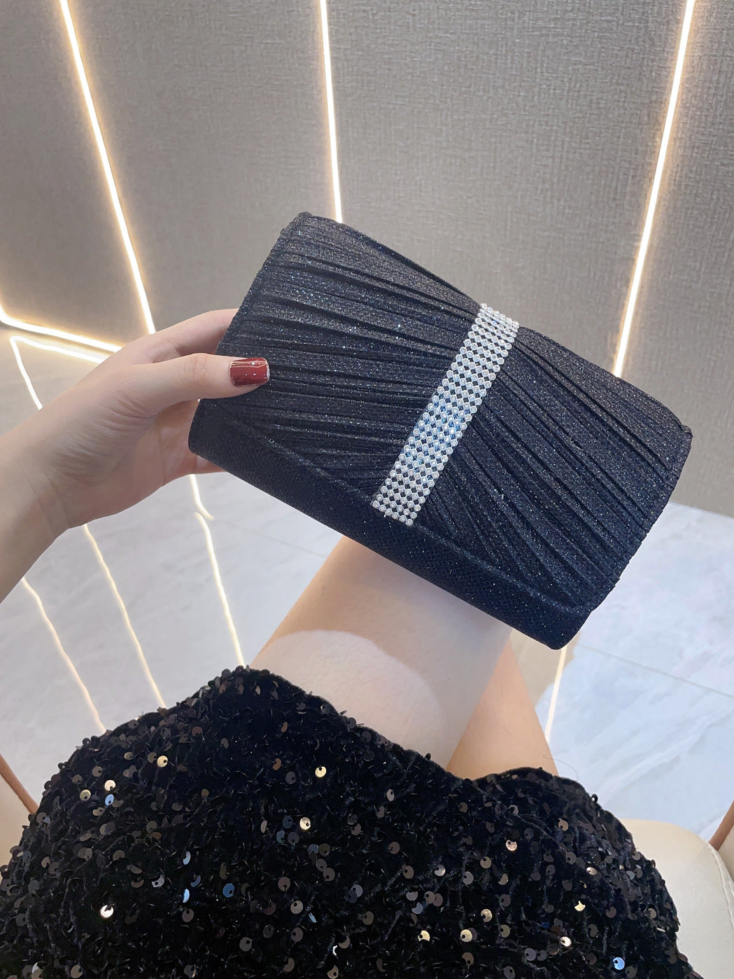 Navy diamond-textured clutch handbag with white stripe and top clasp