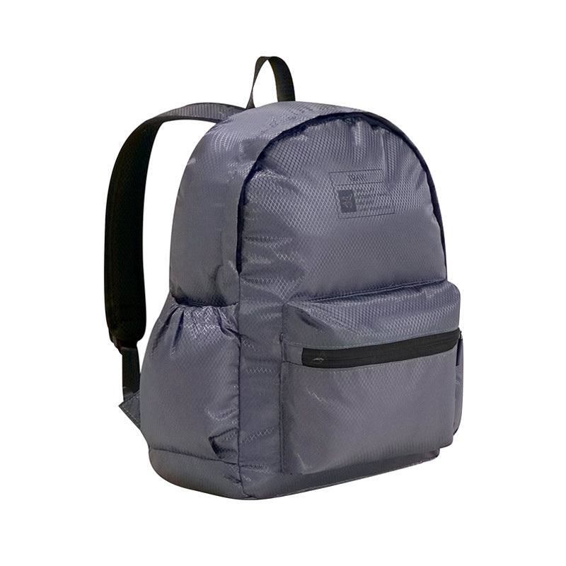 Gray foldable backpack with front zip pocket, top handle, and shoulder straps