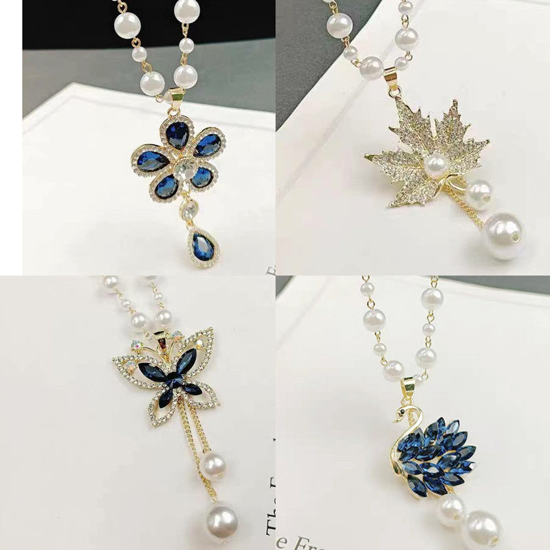 Long pearl necklace set with blue flower and gold star charms