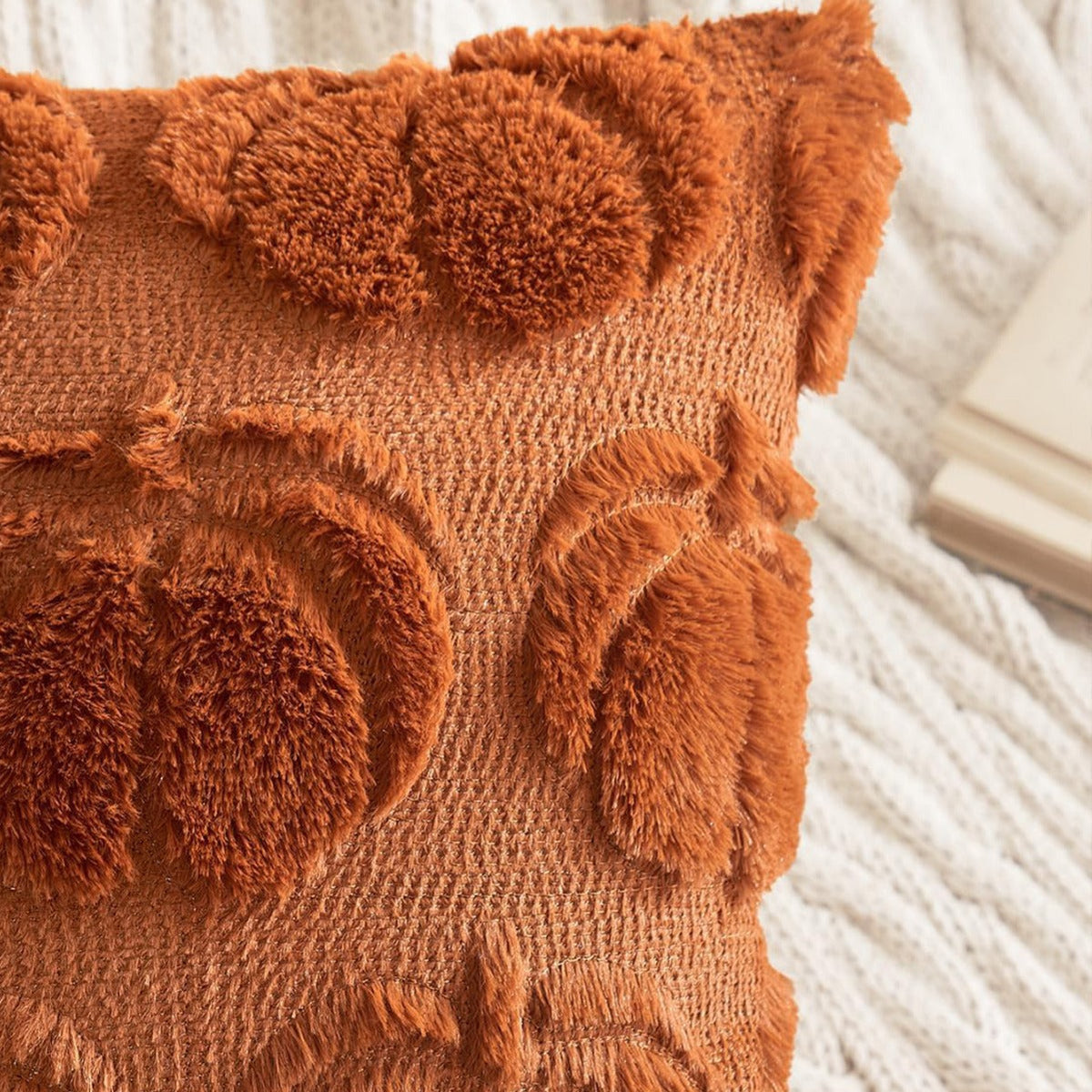 Orange faux fur pillow cover with raised pumpkin texture and fringed edge