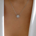 Silver sunburst choker necklace with rhinestone star pendant on fine chain