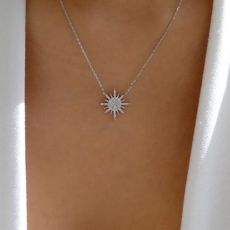 Silver sunburst choker necklace with rhinestone star pendant on fine chain