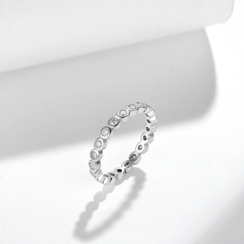 Stackable sterling silver ring set with round clear stones in a linked band