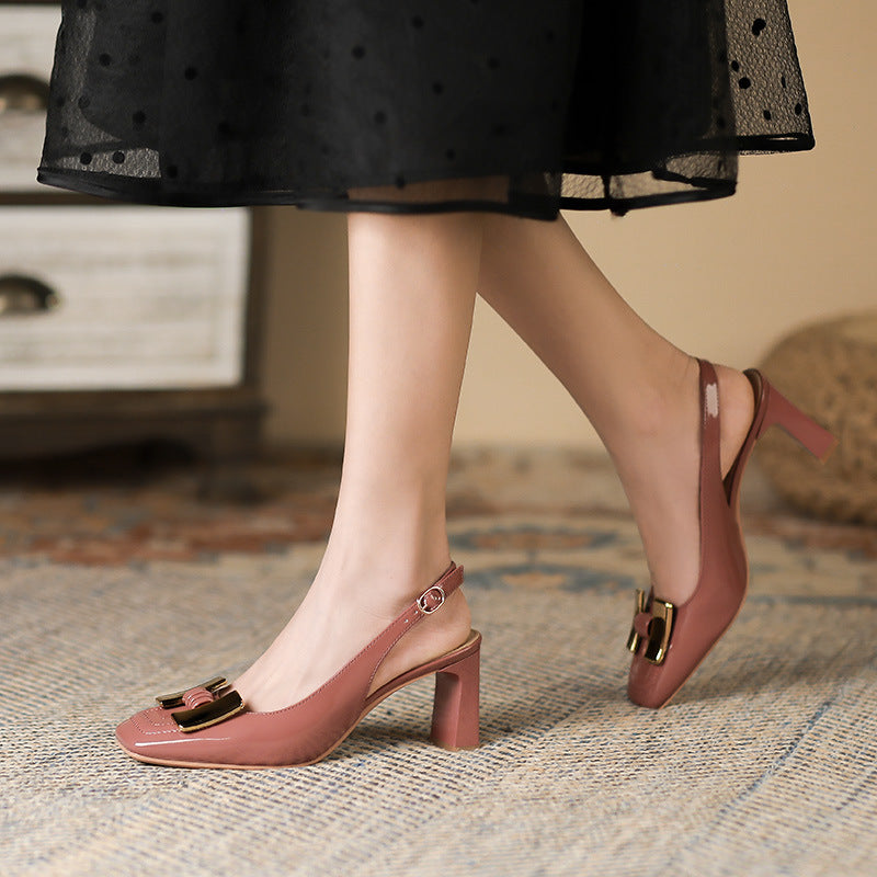 Dusty pink slingback heels with square toe, chunky heel, and gold buckle detail