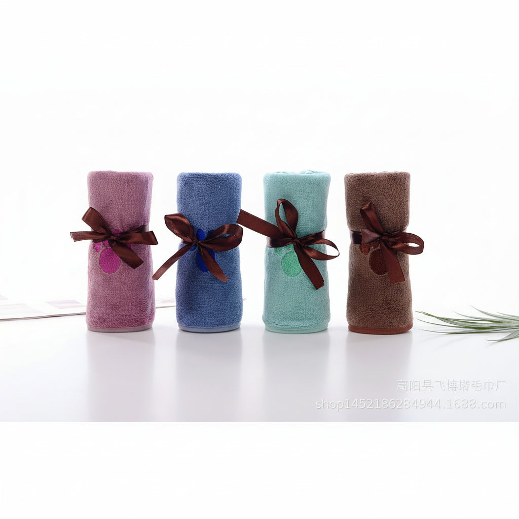 Quick-dry towel set of four mini rolls in pink, blue, teal, and brown with ribbons