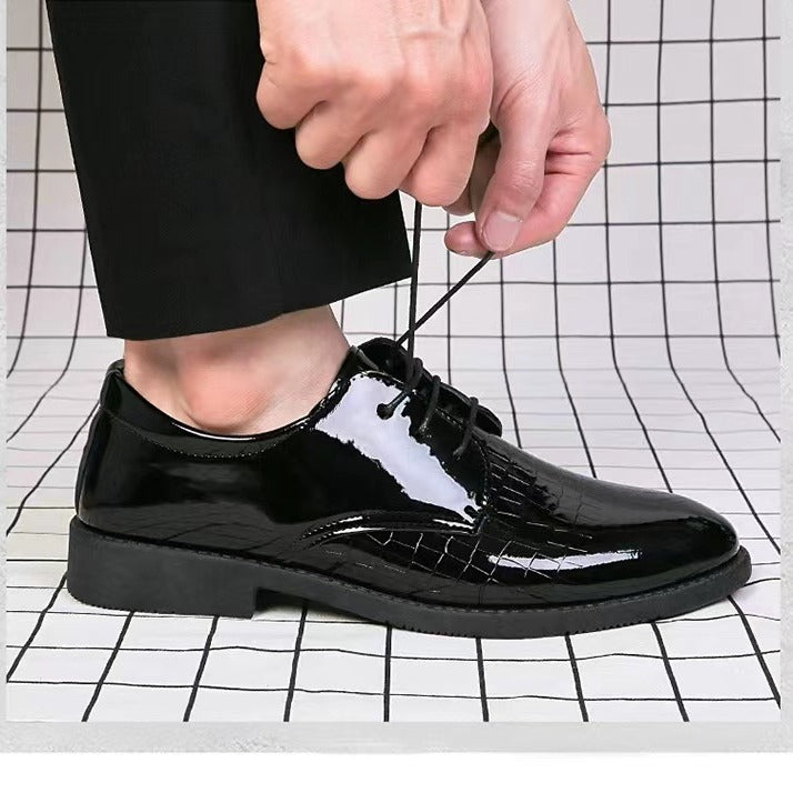 Black patent leather lace-up Oxford shoes with textured vamp and low-profile sole