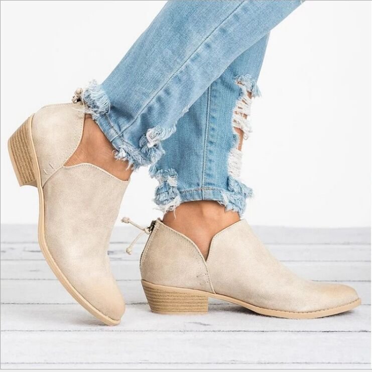 Women’s beige suede ankle boots, pointed toe, low block heel, back zipper, lace-up detail.