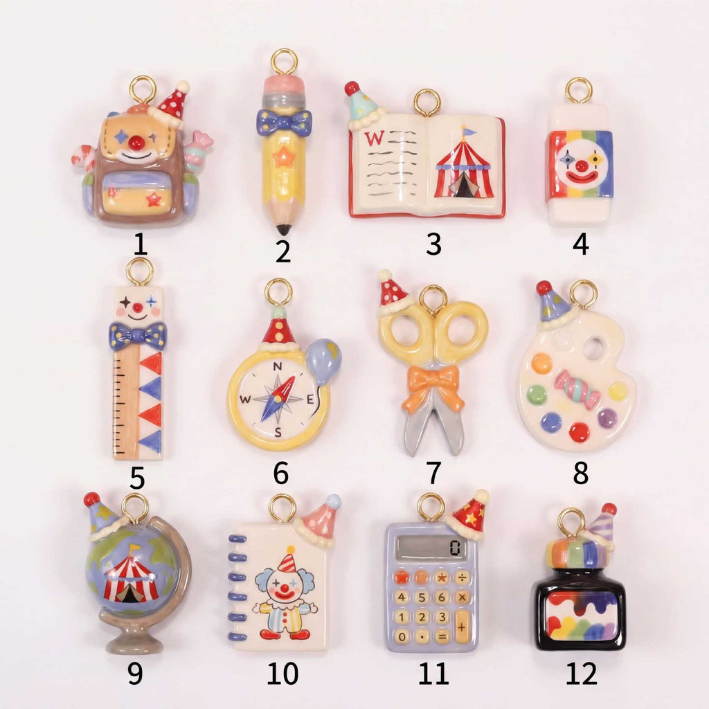Set of 12 miniature school-supply keychain charms with gold rings, labeled 1–12