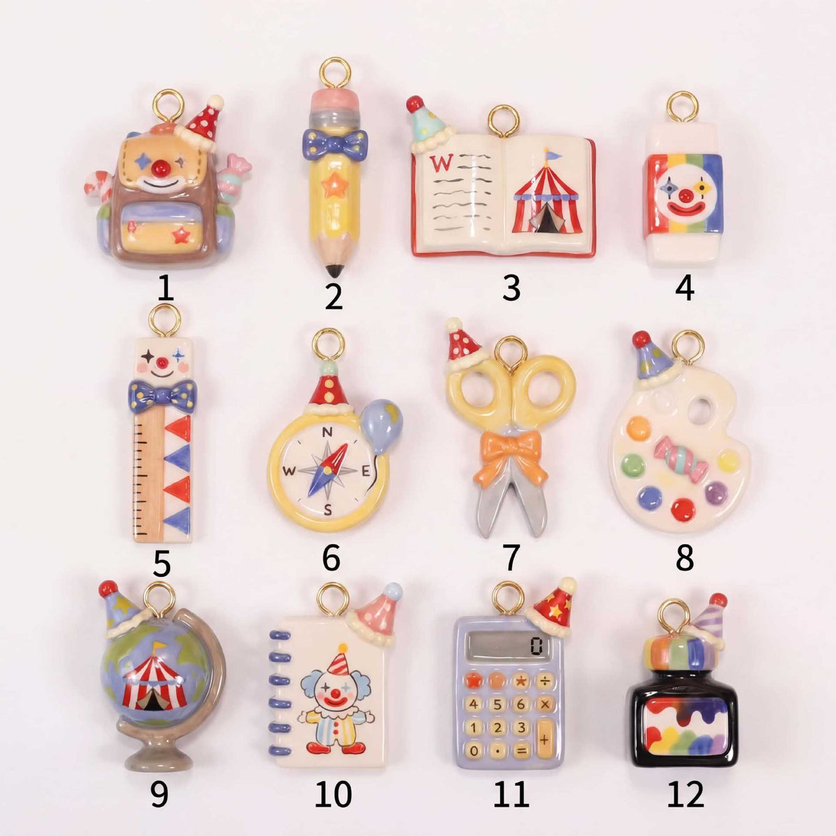 Set of 12 miniature school-supply keychain charms with gold rings, labeled 1–12