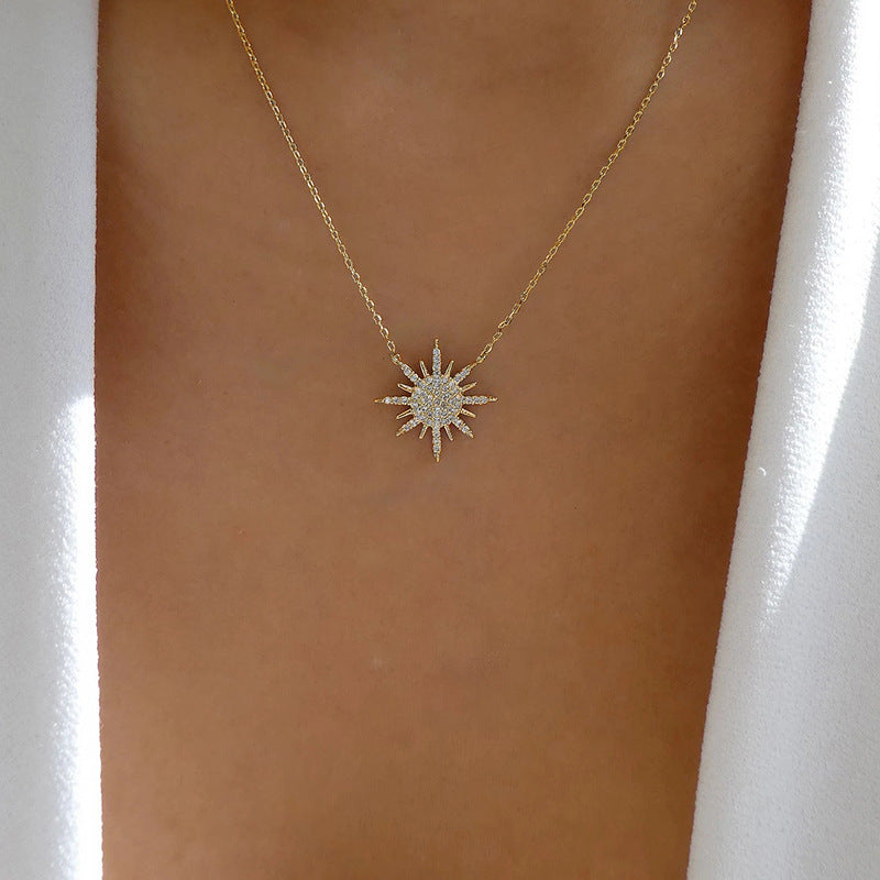 Gold-tone sunburst choker necklace with rhinestone pendant on slim chain