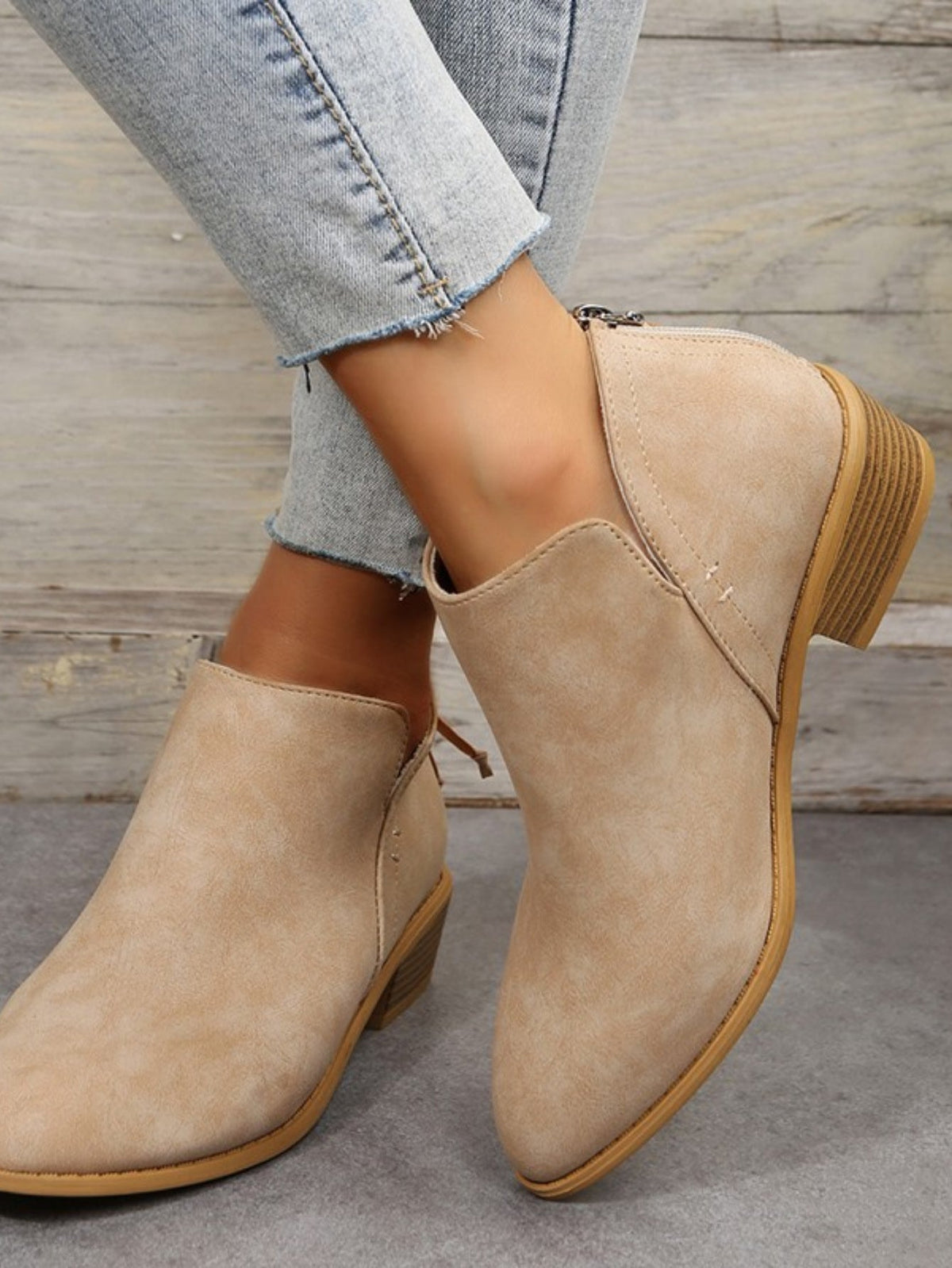 Women’s beige suede ankle boots, pointed toe, low block heel, minimal back zipper.