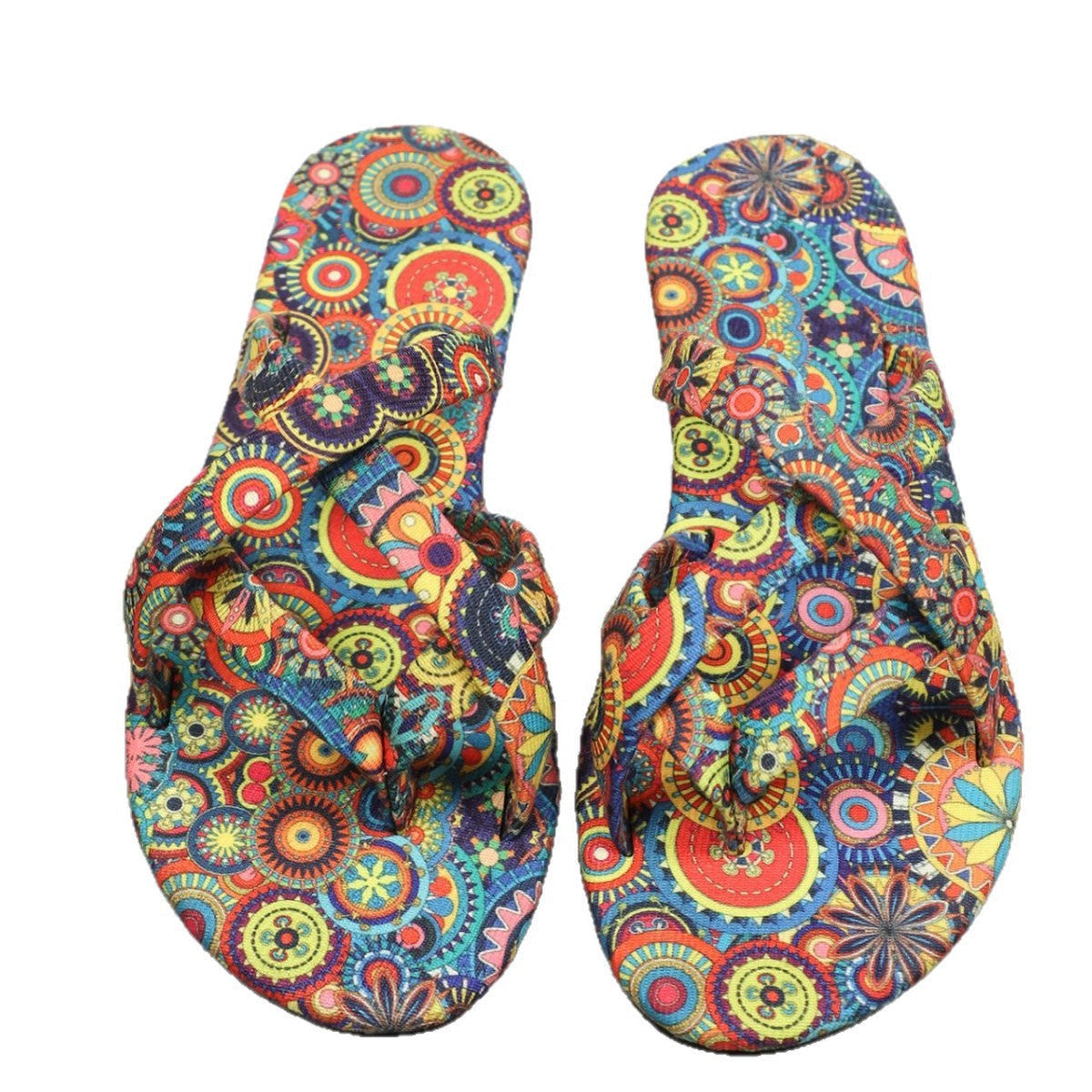 Pair of women’s boho flat printed slippers with multicolor paisley uppers and flat sole.