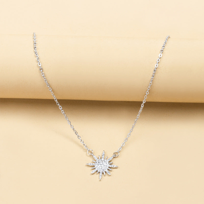 Silver sunburst choker necklace with rhinestone centerpiece and link chain
