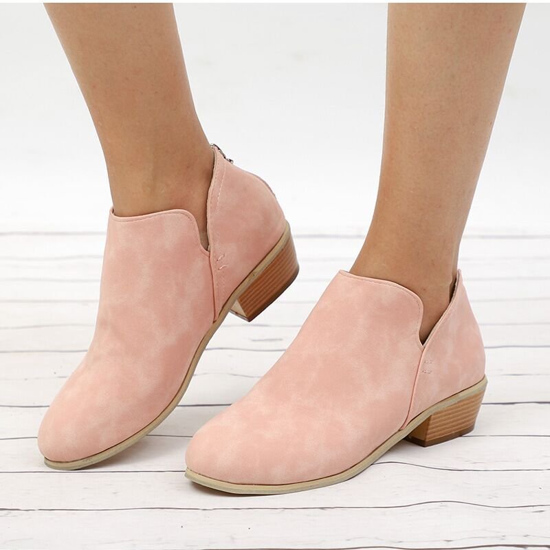 Women’s pink suede ankle boots with pointed toe, low block heel, back zipper.