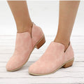 Women’s pink suede ankle boots with pointed toe, low block heel, back zipper.