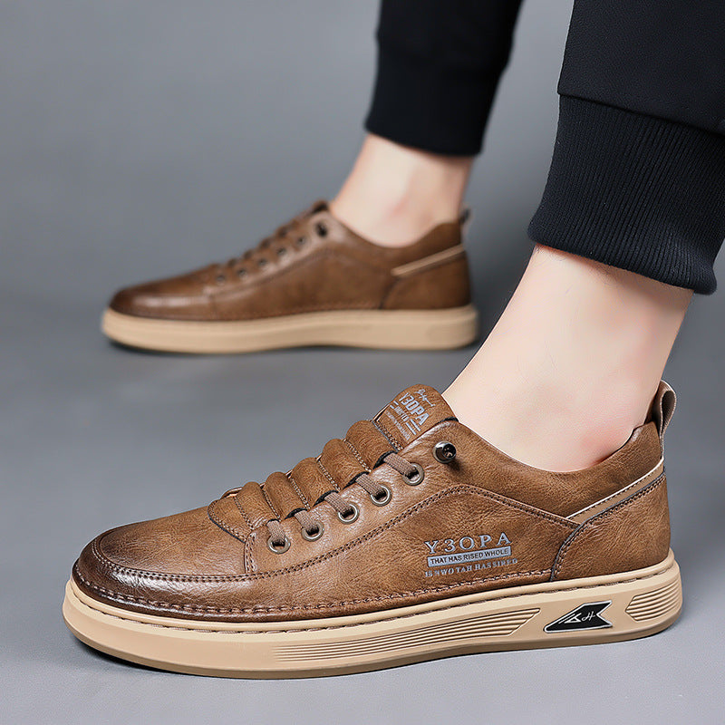 Brown leather lace-up flat shoes on person’s foot, low profile sole