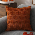 Orange faux fur pillow cover with raised pumpkin pattern on sofa