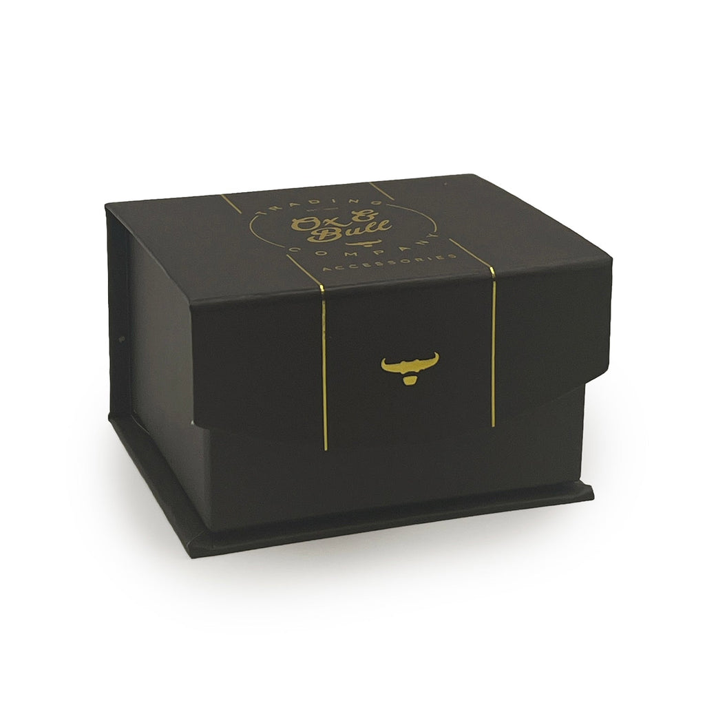Black jewelry gift box with gold logo and ribbon detail