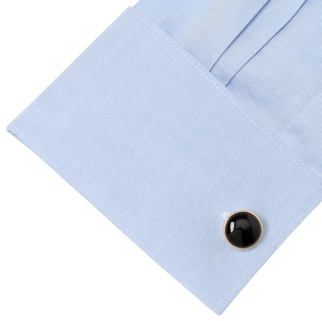 Black onyx cufflink stud on light blue dress shirt