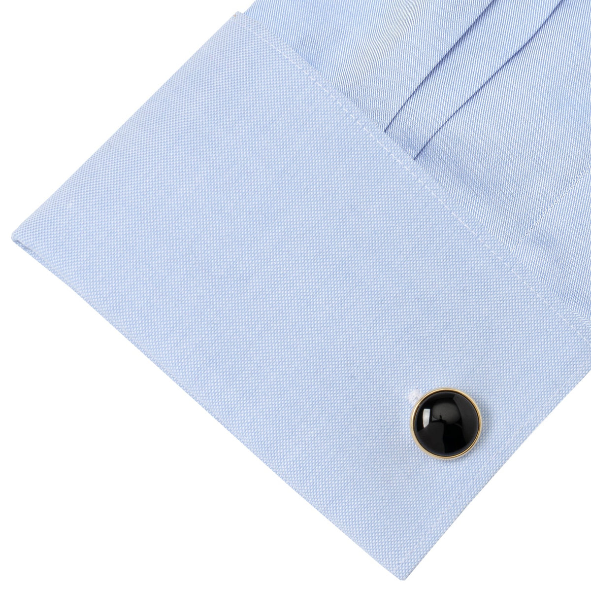 Black onyx cufflink stud on light blue dress shirt
