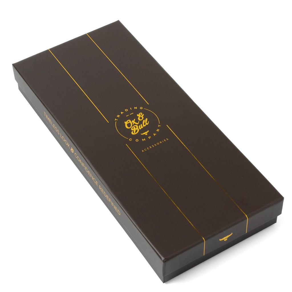 Gift box containing a white silk tuxedo scarf, with gold branding