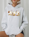 Light gray hoodie with front pocket, hood, and colorful ghost bear Halloween graphic