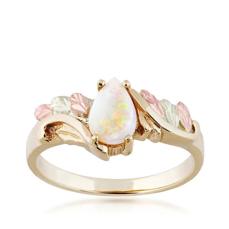 Gold-tone ring with oval opal-like center stone and pink/green floral side design