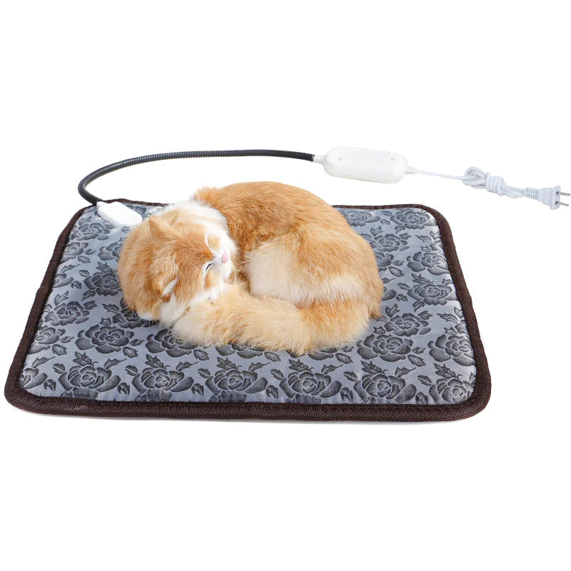 Heated pet blanket with gray rose pattern and brown trim, plugged-in power cord