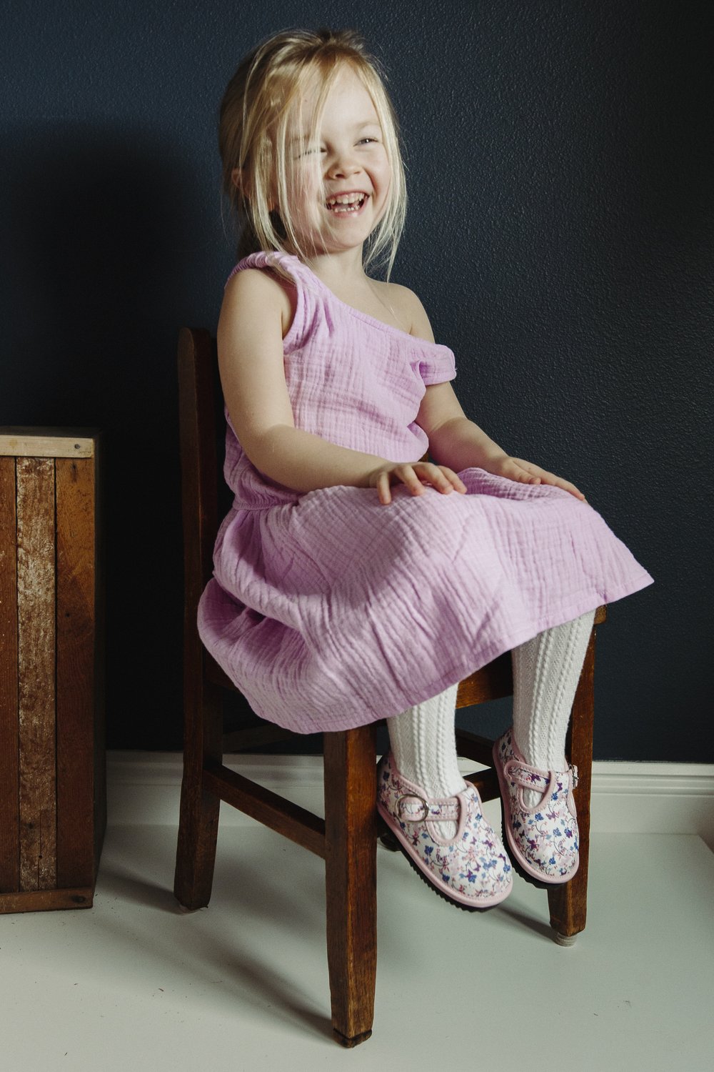 Pink floral easy-on Mary Jane toddler shoes worn while seated