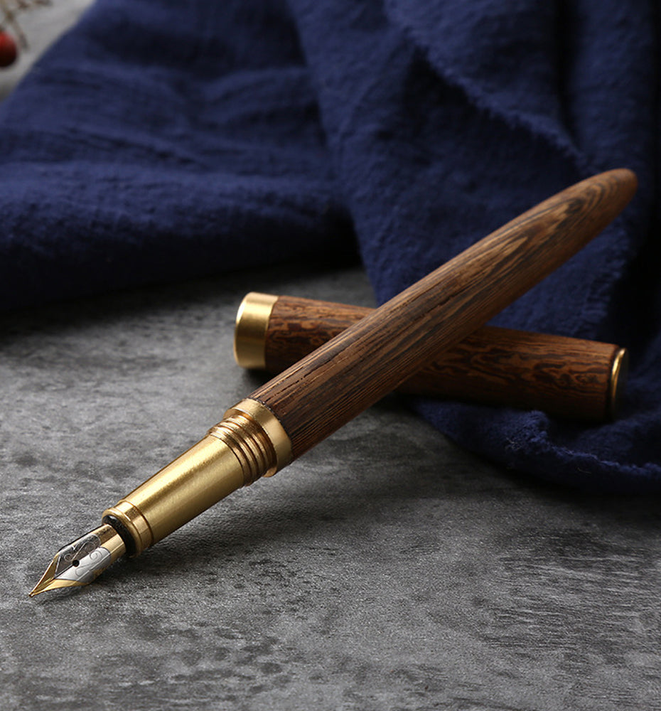 Handmade wood fountain pen with gold-toned body and silver inlay nib