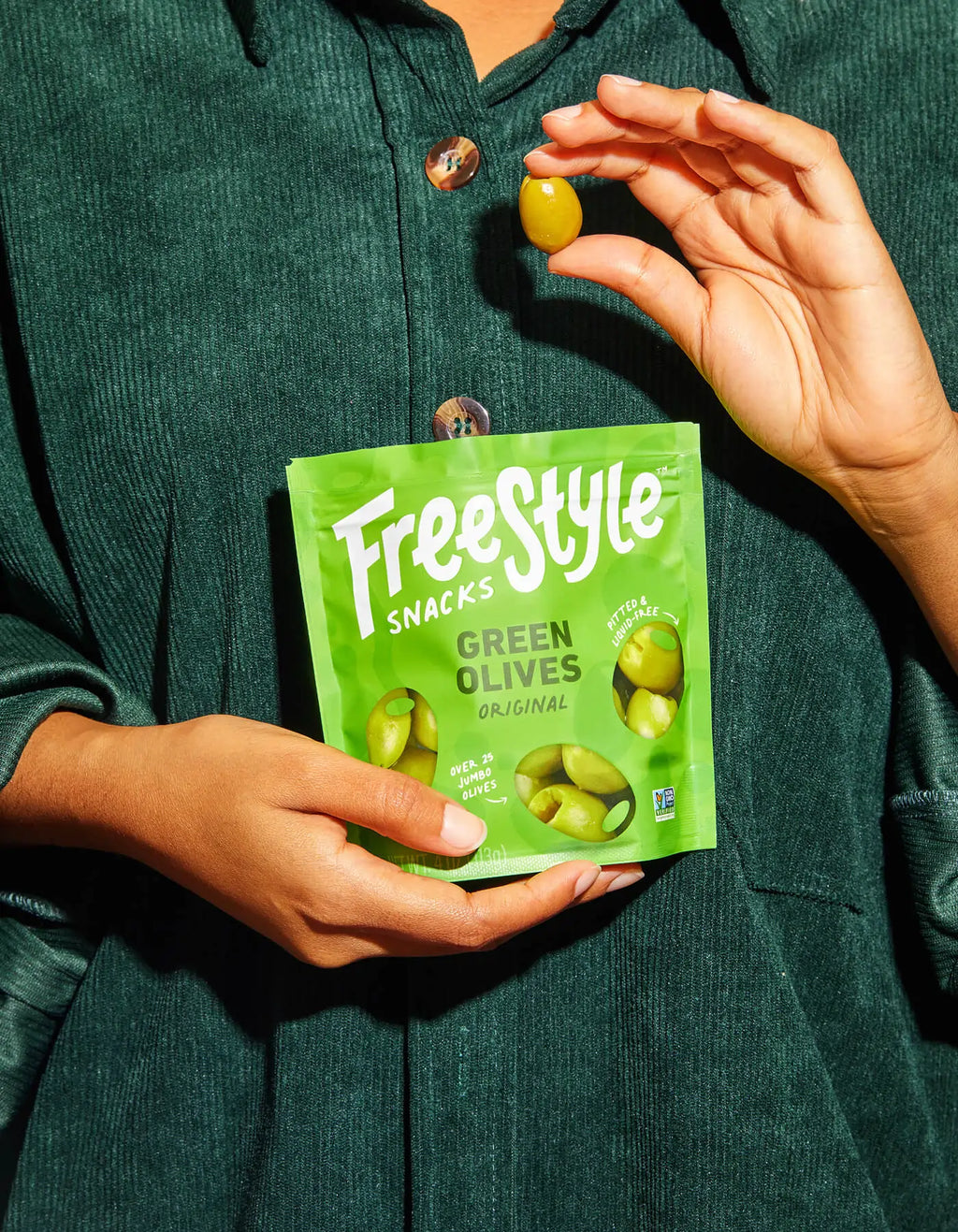 Green olives snack bag held in hands
