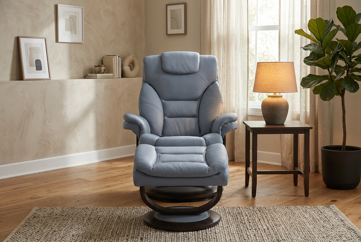 Blue single recliner with matching foot ottoman, tall padded back and curved armrests.