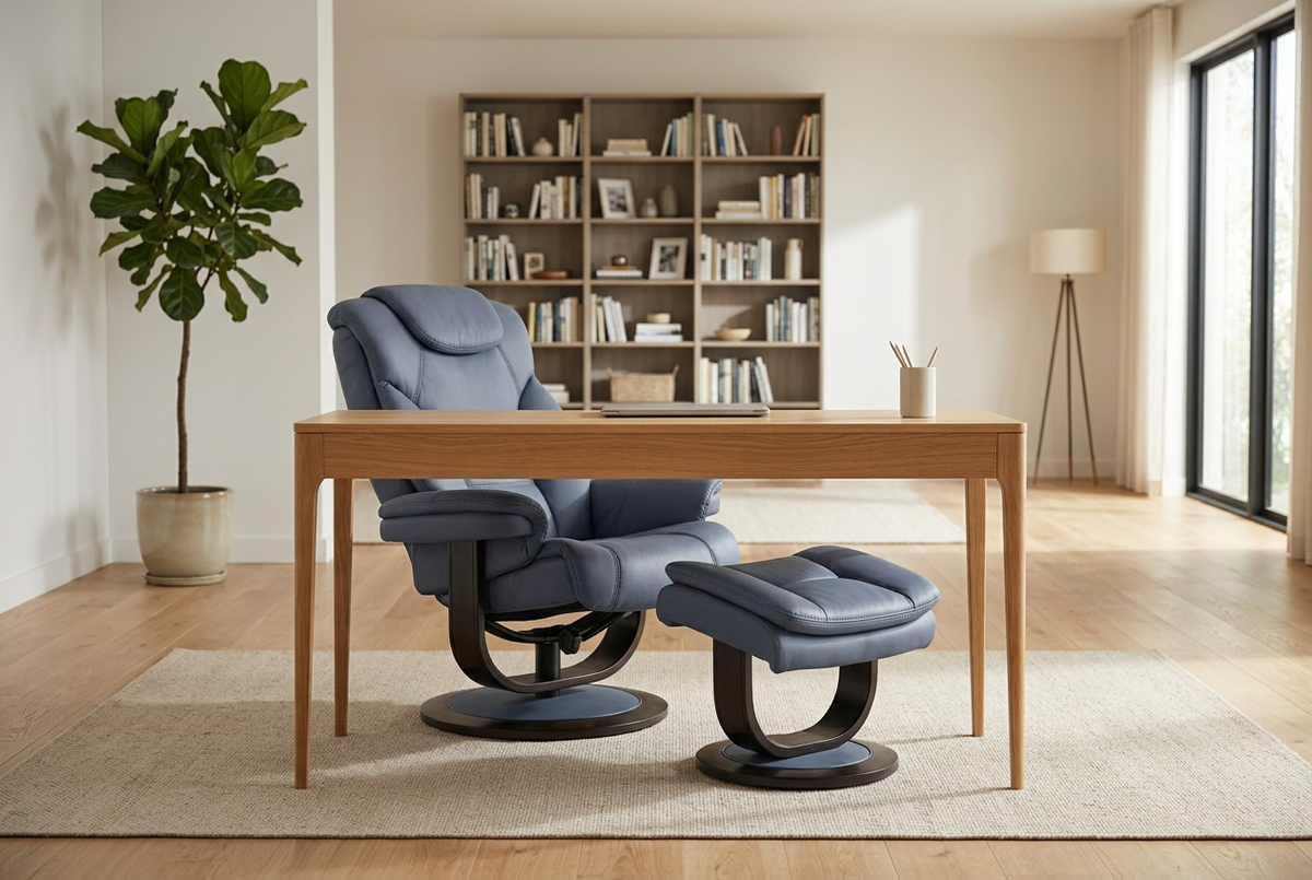 Blue-gray recliner chair with ottoman in front, rounded base and stitched cushion detailing.