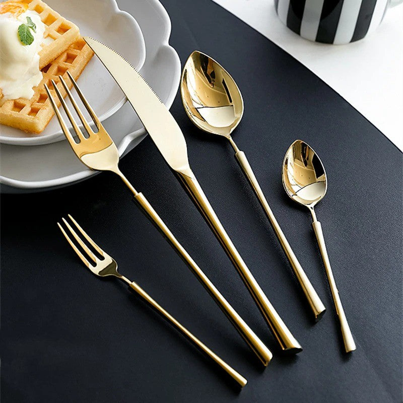 Gold cutlery set: forks, spoon, and knife with reflective handles