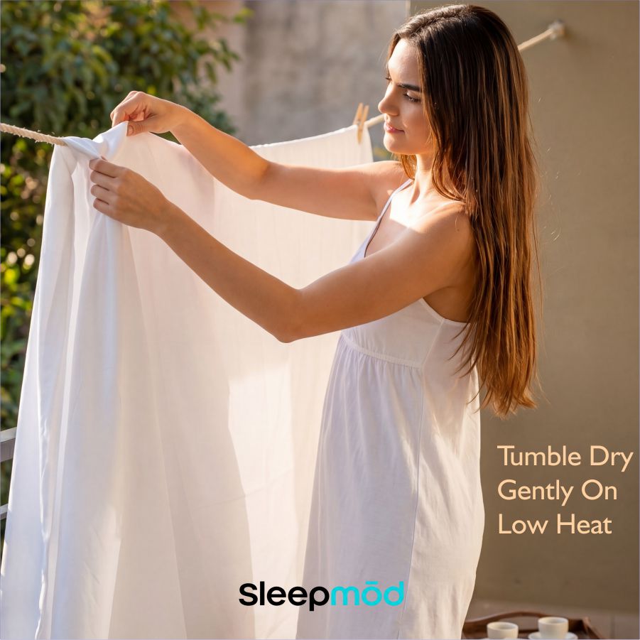 Eucalyptus Tencel sheet set, white sheets laid out and held up for showing.
