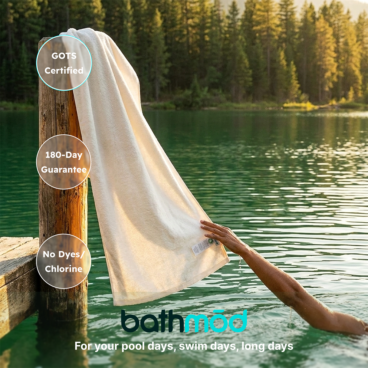White bath sheet draped over a dock post by a lake