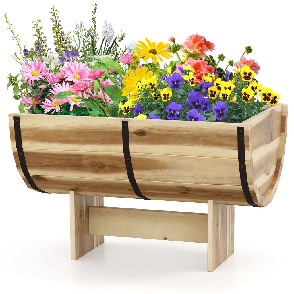 Wooden planter box on legs with black bands, filled with vibrant flowers
