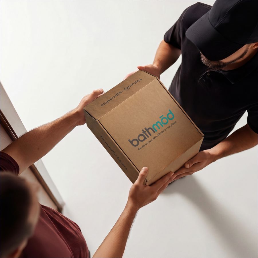 Four-pack bath mats in branded cardboard box being handed between two people
