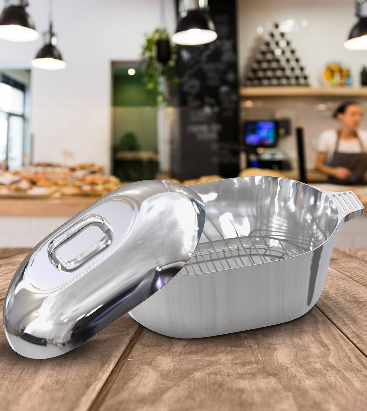 Oval stainless steel dutch oven with domed lid and integrated handles