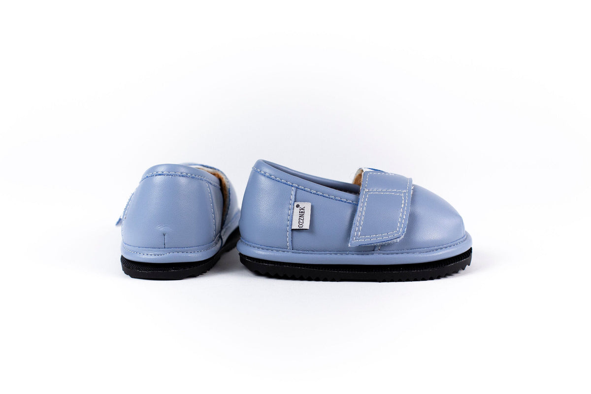 Light blue slip-on barefoot shoes, heel and side view with black rubber sole trim