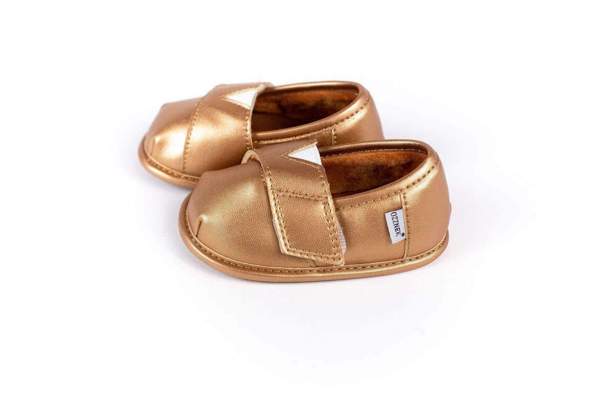 Gold metallic slip-on shoe topper with two hook-and-loop straps, padded collar