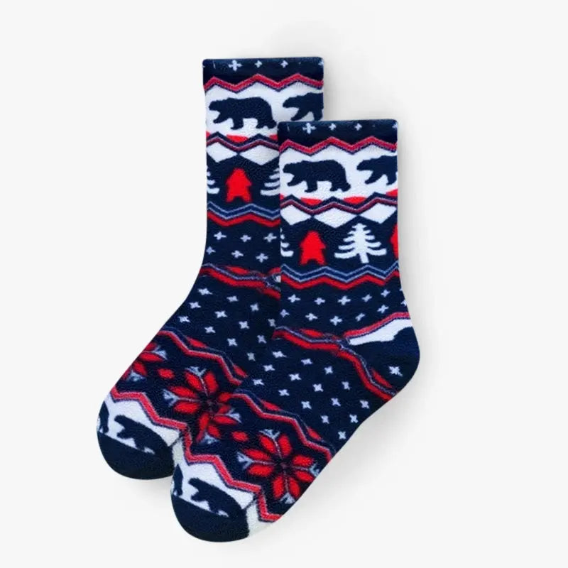 Pair of navy crew socks with polar bear and pine tree pattern and red accents