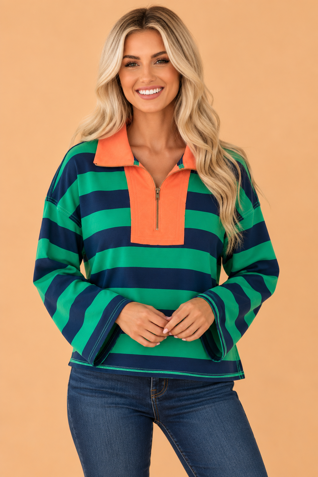 Green striped quarter-zip long sleeve top with orange neck placket and exposed seam