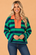 Green striped quarter-zip long sleeve top with orange neck placket and exposed seam