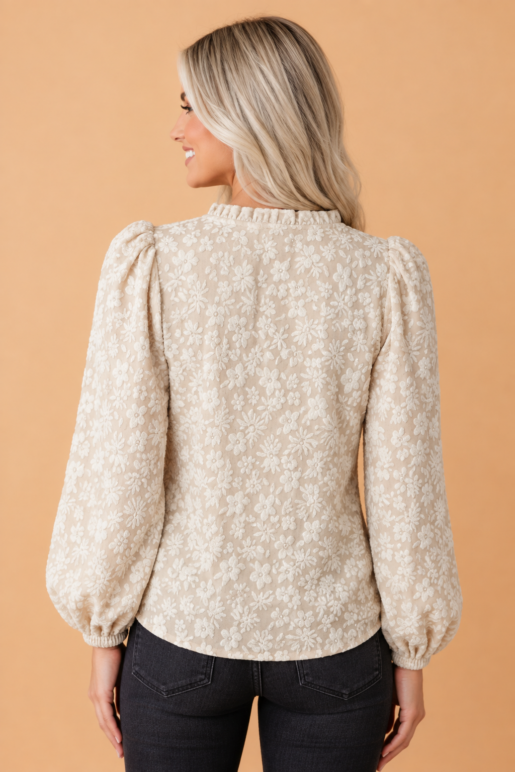 Apricot floral textured blouse back view with long puff sleeves and elastic cuffs