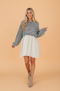 Pocketed long-sleeve mini dress with blue striped top and white patchwork skirt