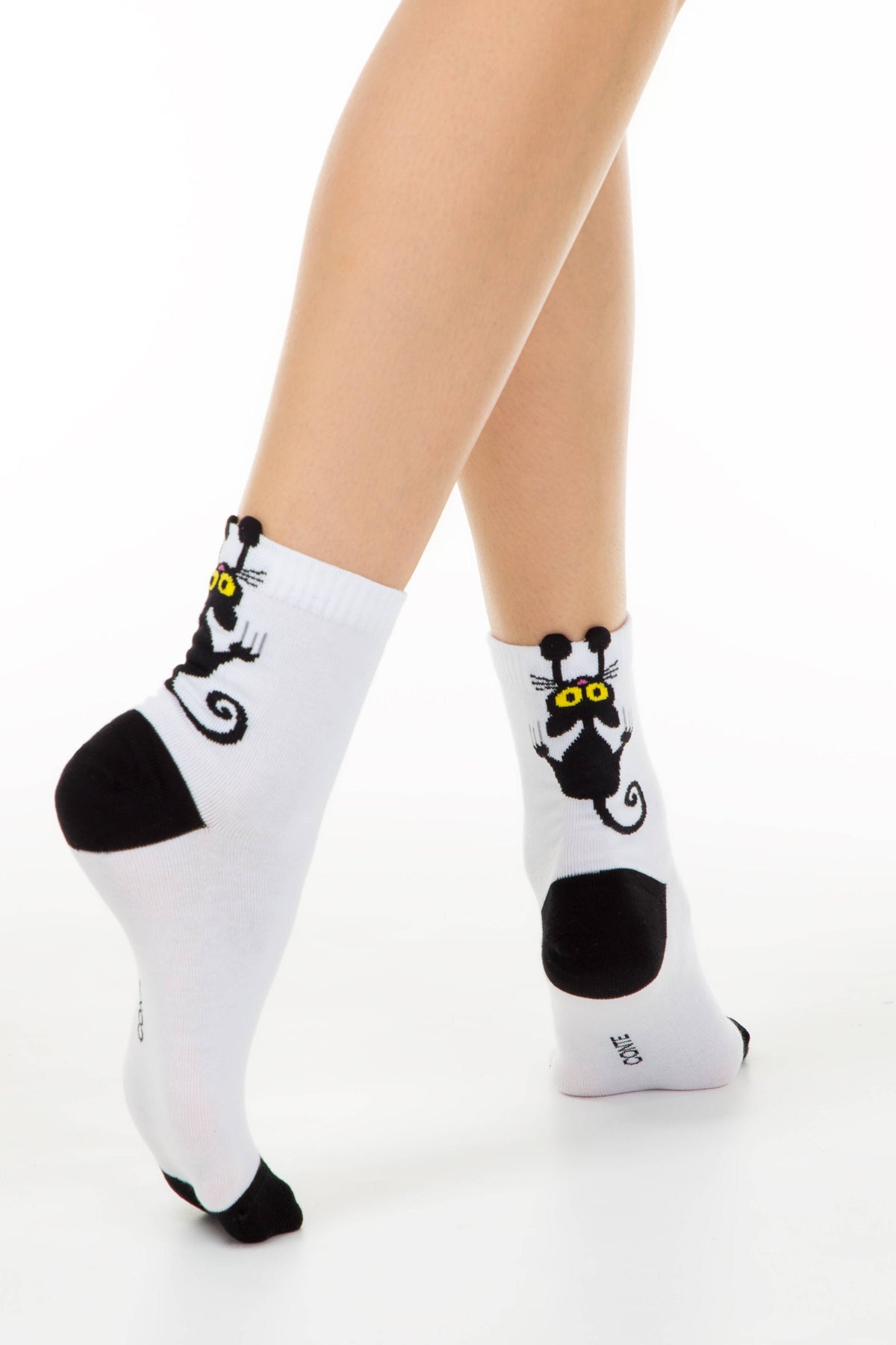 Pair of white cotton crew socks with black cat graphic and black toe heel