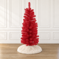 Red tabletop pencil Christmas tree with white flocked base and plastic stand