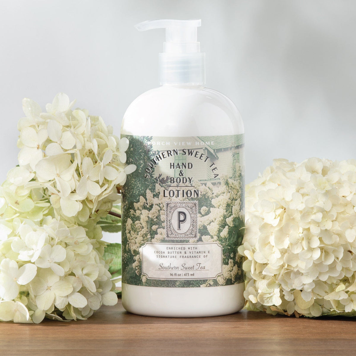 Southern Sweet Tea hand & body lotion pump bottle with hydrangea flowers around it.